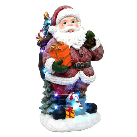 Snedrysset stor Julemand med gavesække og juletræ. Han lyser ægte op og smitter med sit godmodige og smilende ansigt, fra Sigro. 