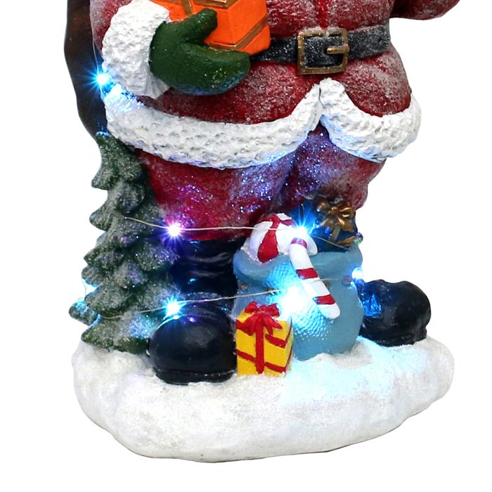 Julemanden holder en gave klar – snefnug og glitter giver det klassiske motiv et ekstra strejf af julemagi