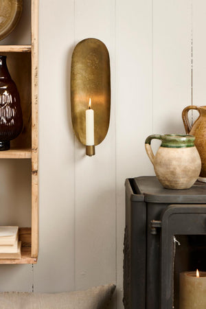 Wall candle holders with lights hanging on a white wall from Ib Laursen