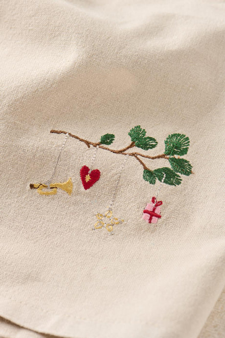 Design on Tradition fabric napkin — fir branch with hanging Christmas ornaments by Ib Laursen
