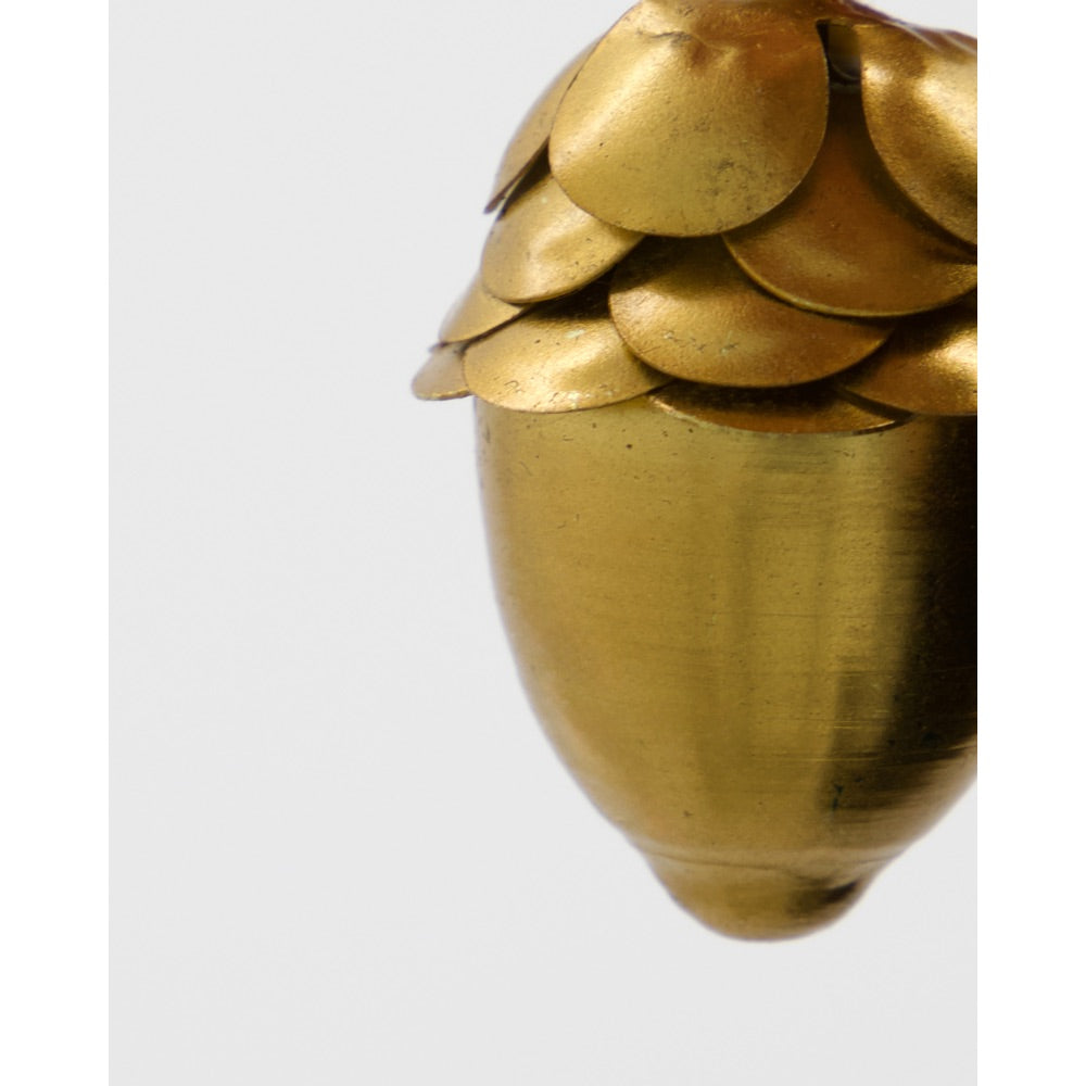 Close-up of a gold metal acorn from House Doctor
