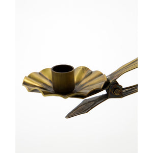 Close-up of a House Doctor candle holder in antique gold with clip
