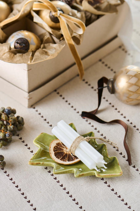 Green ceramic Christmas tree-shaped bowl by Ib Laursen with tealight and dried orange slice