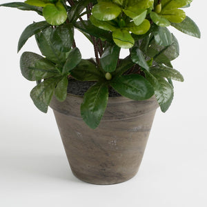 Grå lerpotte med kunstig azalea i