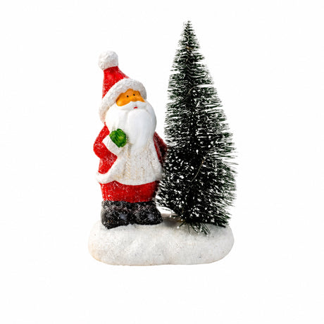 Santa Claus or snowman next to lighted Christmas tree