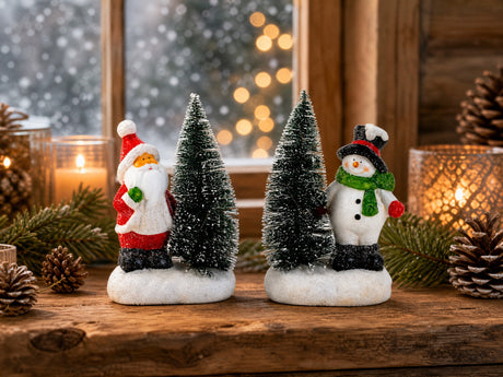 Santa Claus or snowman next to lighted Christmas tree