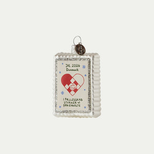 Christmas seal ornament 2026 with woven Christmas heart, hands holding each other, and a silver glitter edge