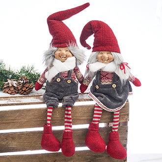 Christmas gnome trolls in red and gray clothes with dangling legs from Pobra