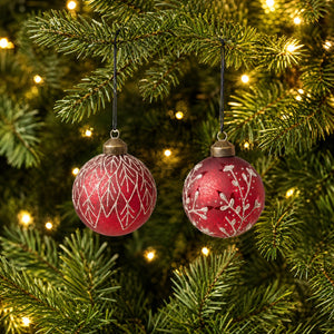 Red Christmas bauble with leaves or branches