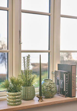 Antique gold leaf candlestick from Speedtsberg on a windowsill with succulents in pot covers