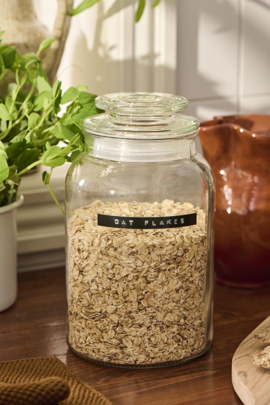 Storage jars from Ib Laursen filled with dry goods on a rustic kitchen table