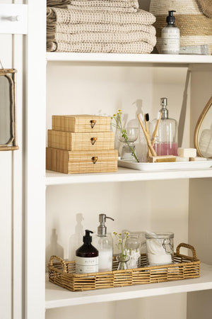 Bright bathroom with beige towels from the Liseleje series and wooden shelves with bathroom accessories
