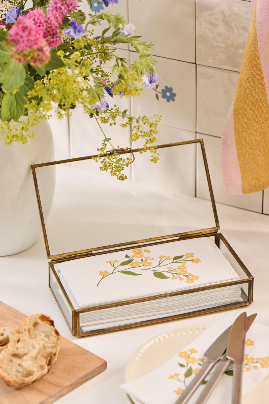 Open elongated Solitaire glass box from Ib Laursen on a bright table with flowers and small decorative items
