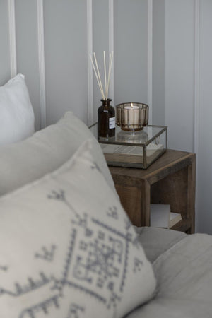Solitaire glass box by Ib Laursen used as decorative storage on a bedside table in a bright bedroom