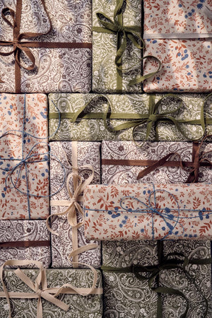 Wrapped gifts in patterned Ib Laursen wrapping paper in assorted colors and designs