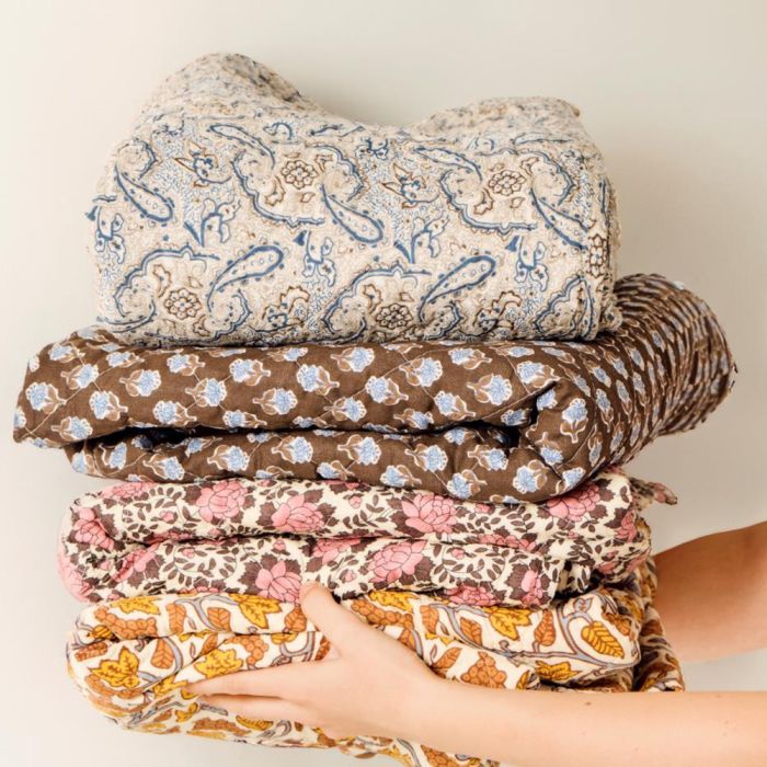 Brown quilt with blue floral pattern